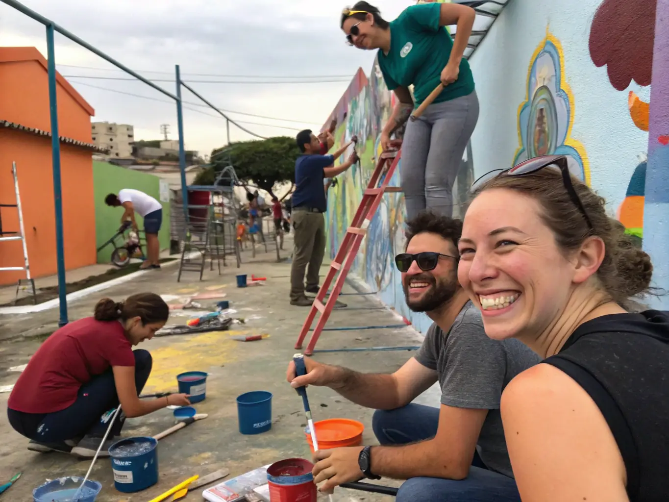 Volunteers working on a community art project, painting a mural on a local building, fostering community engagement and artistic expression.